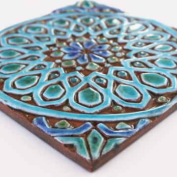 Turquoise handmade tile with decorative relief. Decorative tile handmade in Spain.