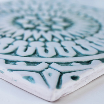 Handmade tile with carved relief for kitchens, bathrooms and outdoor wall art. Decorative tile handmade in Spain in aqua & white.