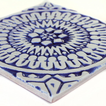 Blue and white handmade tile with relief for kitchens bathrooms and outdoor wall art. Decorative tile handmade in Spain.