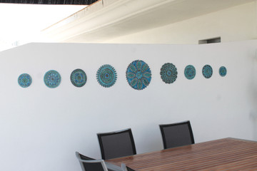 These circular tiles make beautiful outdoor wall art.  Aqua and white wall hangings for kitchens, bathrooms and wall decor. Our decorative tiles can also be combined with our other handmade tiles to make larger wall art installations.