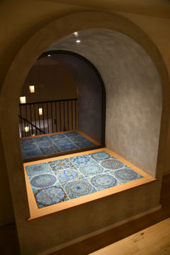 Handmade tiles used in seating area of window.  Decorative tiles handmade in Spain. Turquoise relief tiles.