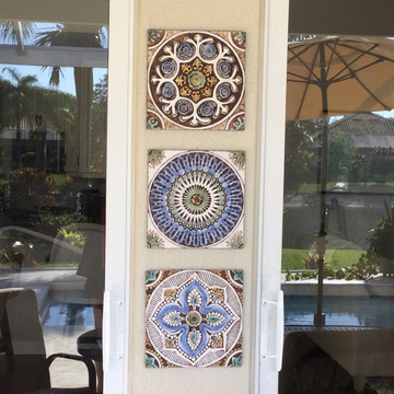 Patio wall art installation using ceramic tiles carved with relief. Spanish tile for kitchens, bathrooms and wall art. Handmade in Spain.