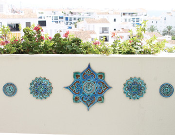 These Moroccan tiles are glazed in turquoise and make unique wall hangings for kitchens and bathrooms. Our decorative tiles also make wonderful outdoor wall art.  Circle garden decor handmade in Spain.