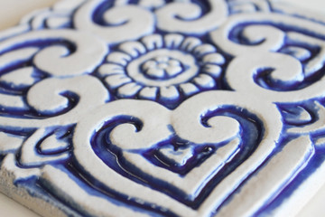 Blue and white handmade tile with relief for kitchens, bathrooms and outdoor wall art. Decorative tile handmade in Spain.