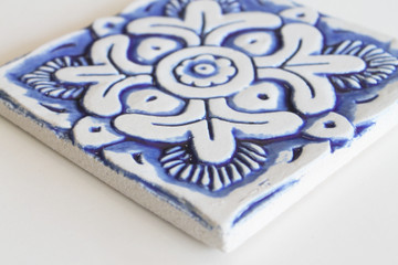 Blue and white handmade tile with relief for kitchens, bathrooms and outdoor wall art. Decorative tile handmade in Spain.