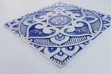 Blue and white handmade tile with relief. Decorative tile handmade in Spain.