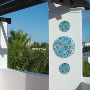 These handmade tiles make a unique wall art installation.  Our decorative tiles make wonderful outdoor wall art, either on a garden column or home entrance. Turquoise circle garden decor handmade in Spain.