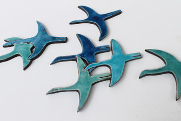 Create your unique wall art installation with these turquoise abstract flying birds. Ceramic wall art for kitchens, bathrooms and outdoor wall decor. Our handmade tiles make a beautiful wall art installations.