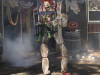 Giant scary clown animatronic with glowing eyes and orange hair