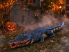 Realistic 4 foot swamp alligator Halloween prop in a foggy yard display with pumpkins and lanterns