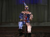 creepy clown prop riding tricycle with glowing eyes
