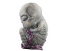 Alien Baby Doll Prop holding a purple blanket