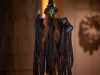 hanging green witch halloween decoration with cauldron