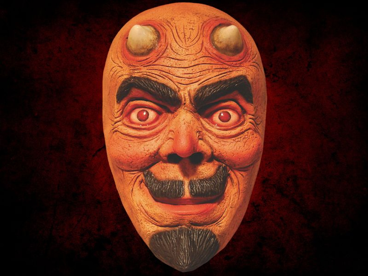 close-up of Aaron Lewis devil mask with goatee and eerie smile