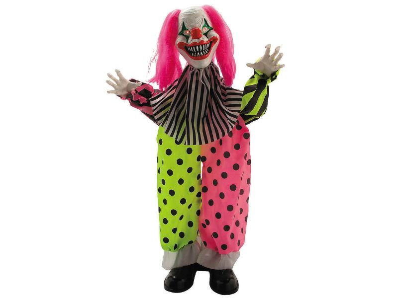 standing pink haired clown Halloween decoration near party setup