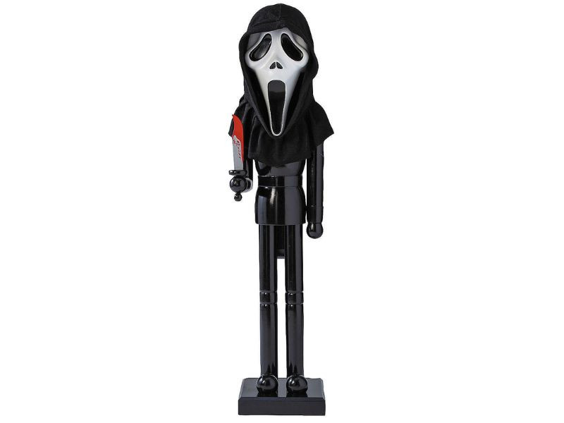 Close-up of Ghost Face mask and painted wood knife on nutcracker prop