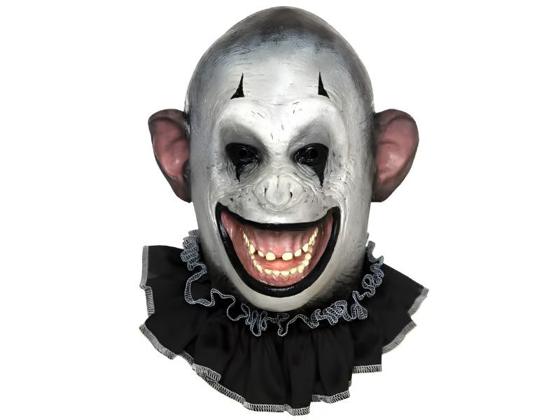 Scary monkey clown mask side view with cracked white face, black ruffle collar, and wide toothy grin