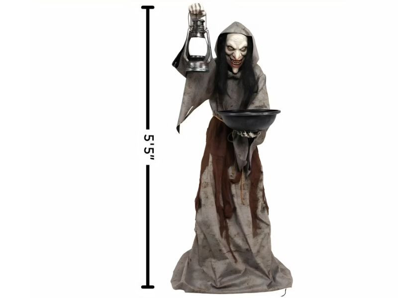life size halloween witch prop holding lantern and bowl