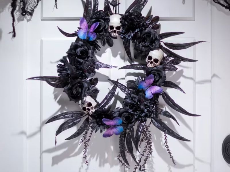 dark floral halloween wreath with skulls spiders butterflies
