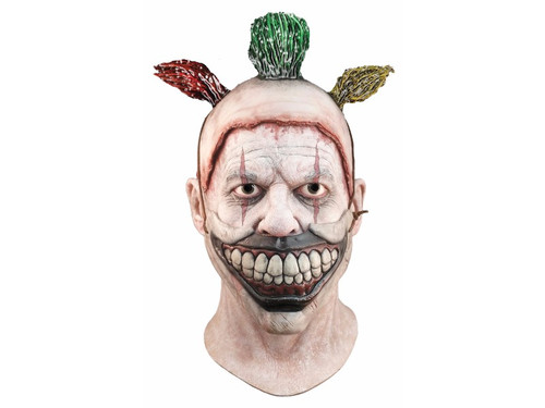 From the horrifying FX network television show American Horror Story comes this great Twisty The Clown Mask! Full over-the-head latex mask of your favorite killer clown. This mask is the same style as our deluxe model but the evil grinning smile is non removable and has painted on hair sprigs. One size fits most adults.