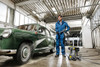 Karcher Pro HD 400 ED electric pressure washer cleaning a vintage green car inside an automotive wash bay