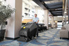 Karcher Commodore Duo walk-behind carpet cleaning machine used in hotel hallway for encapsulation and extraction cleaning