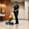 TASKI ULTIMAXX 360 auto scrubber used by operator cleaning commercial tile floor