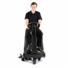 Young operator seated on the NSS Champ 2417 RB ride-on automatic floor scrubber shown from the front on a white studio background, highlighting compact ride-on design, steering controls, and commercial cleaning configuration.