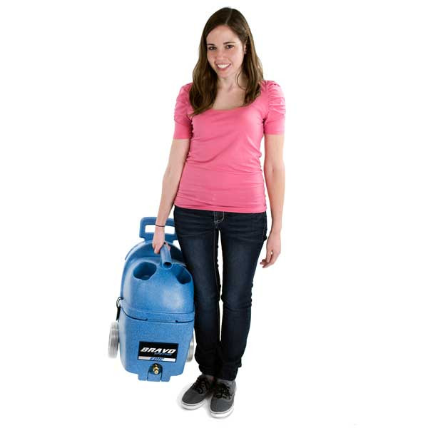 Lightweight EDIC Bravo Spotter portable carpet extractor being carried by operator