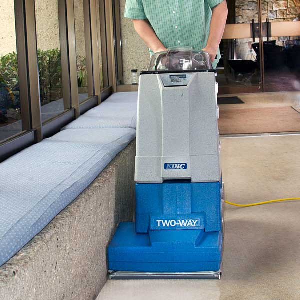 EDIC Supernova self-contained extractor cleaning carpet edges along a wall