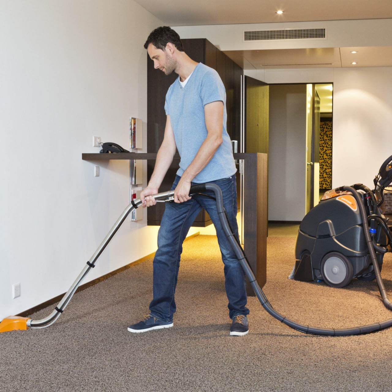 TASKI procarpet 45 upholstery cleaning with hose and wand attachment on commercial carpet in hotel room