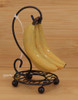 Bananas on Metal Stand Ornament Wood Background