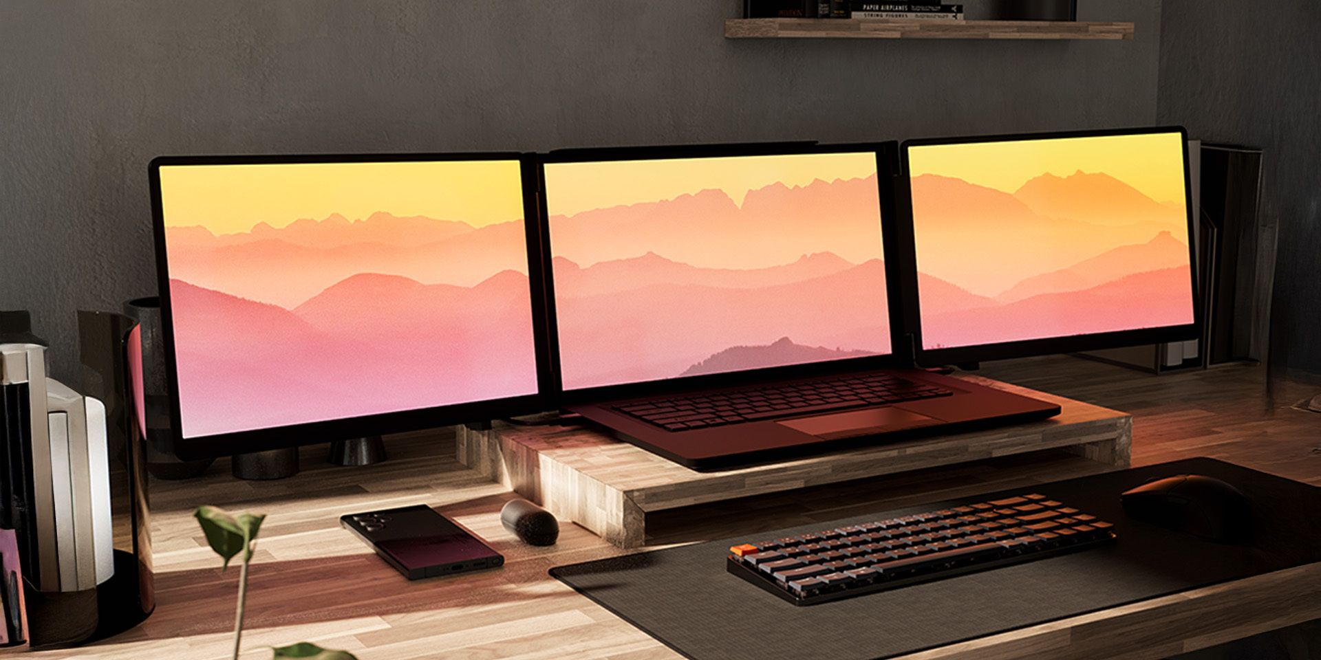 A side-by-side view of two premium desk setups, each showcasing a laptop seamlessly expanded into a tri-screen display with the Monduo portable monitor accessory.