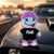 Lil PUKE soft toy displayed on a muscle car at a burnout event