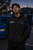 Model wearing the black Canberra Subaru Meetups hoodie showing the dual chest graphics