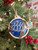 Laser wood ornament with blue resin.
