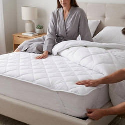white-premium-microfibre-mattress-topper-on-bed-hands-demonstrating-elasticated-corners-soft-microfibre-texture-bedroom-lifestyle