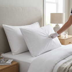 white-130-thread-count-bag-style-pillowcases-on-bed-hand-demonstrating-soft-polycotton-fabric-bag-closure-design-bedroom-lifestyle