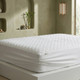 white-quilted-mattress-protector-fitted-on-mattress-close-up-showing-quilted-pattern-waterproof-protection-elasticated-corners