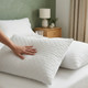 white-quilted-waterproof-pillow-protector-water-demonstration-water-poured-on-quilted-fabric-showing-waterproof-protection-texture-visible