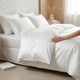 white-400-thread-count-100-percent-cotton-sateen-bedding-on-bed-hand-demonstrating-premium-sateen-finish-bedroom-lifestyle