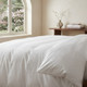 white-200-thread-count-satin-stripe-duvet-cover-on-bed-close-up-showing-stripe-pattern-and-easy-care-finish-bedroom-lifestyle