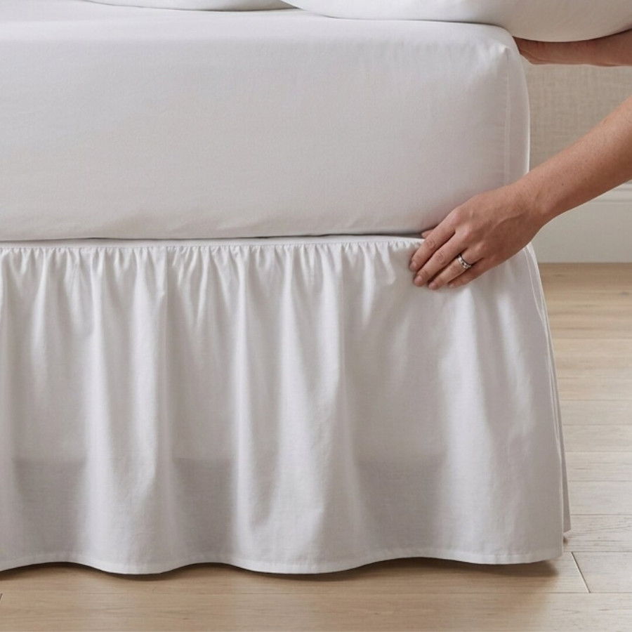 white-200-thread-count-percale-base-valance-on-bed-hand-demonstrating-crisp-percale-weave-base-skirt-style-bedroom-lifestyle