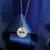 Gold Evil Eye Mother of Pearl Pendant displayed on navy blue ribbon – lifestyle jewellery photo
