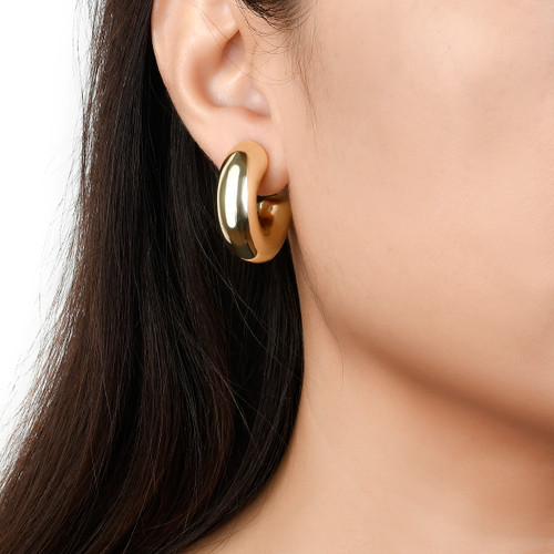 model wearing chunky gold circle open hoop earrings