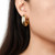 model wearing chunky gold circle open hoop earrings