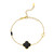 gold clover bracelet with black enamel flower with tiny black clover on the side