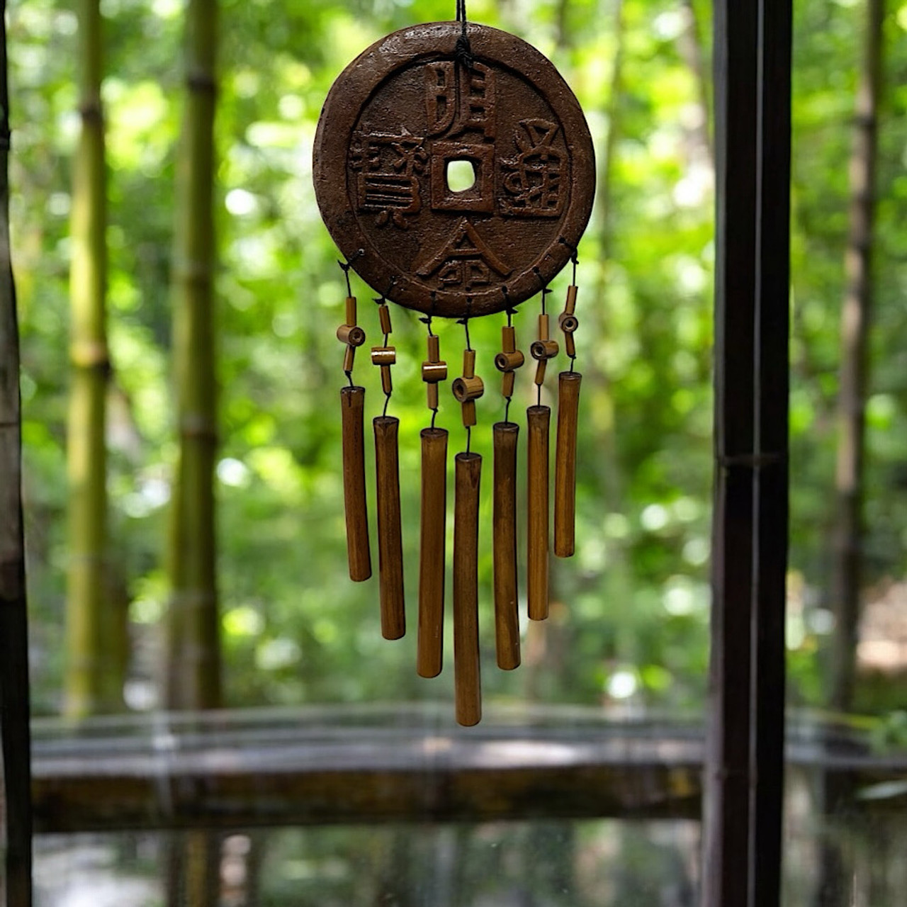 Boho bamboo wind chime with ceramic good fortune coin, 45cm tall, adds zen charm outdoors. Boho bamboo wind chime with ceramic good fortune coin, 45cm tall, adds zen charm outdoors.