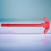 .308 ar10 holy red anodized charging handle laying on a shelf.