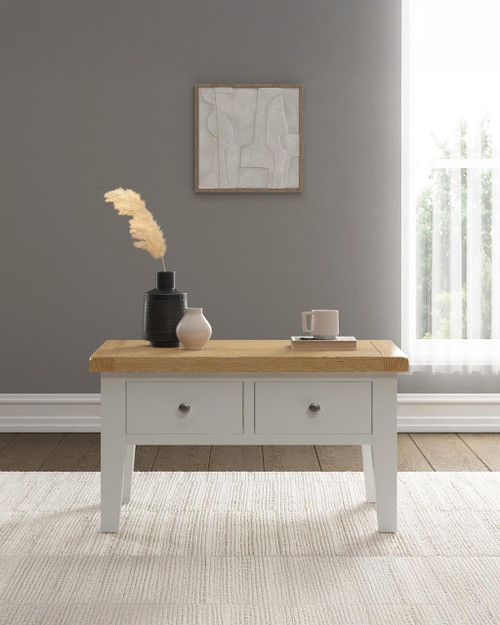 Hampton Ivory 2 Drawer Coffee Table HI300-301-090, modern white coffee table with wooden top, two drawers with round metal knobs, in a minimalist living room setting.